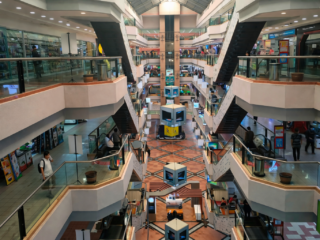 mall atrium with escalators and shops